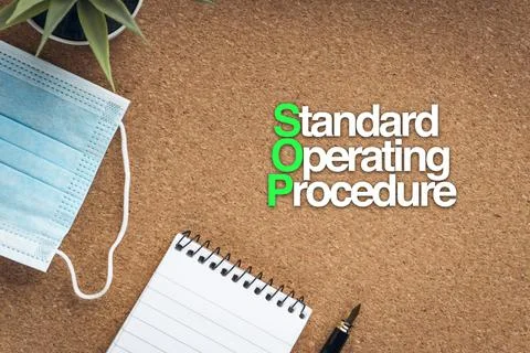 STANDARD OPERATING PROCEDURE SOP text with face mask, notepad, fountain pen a Stock Photos