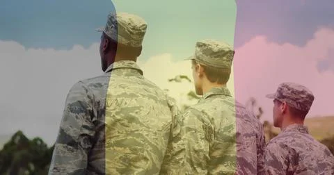 Standing 3 troops in digital camo uniforms and patrol caps facing horizon on Stock Photos