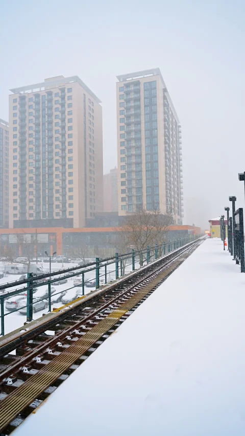 Standing at the above-ground station covered with fluffy snow. Waiting for train Stock Footage 335651161