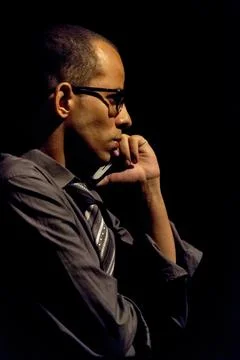 Standing actor representing a character in a theater. Black background in the Stock Photos