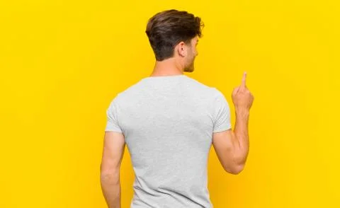 Standing and pointing to object on copy space, rear view Stock Photos