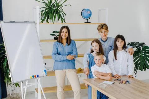 Standing and posing. Smiling together. Group of children of different ages st Stock Photos