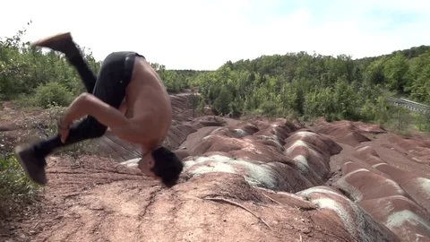 Standing Back Flip on Red Dunes Slow Motion Stock Footage 80072252