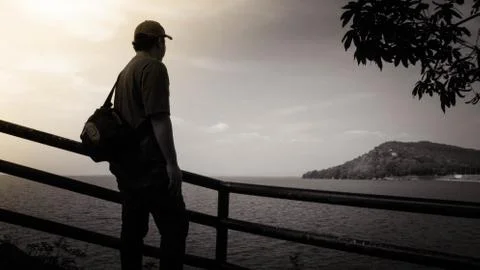 Standing backlit sunset lighting back view lake Stock Photos