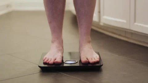 Standing on bathroom scales Stock Footage 282322113