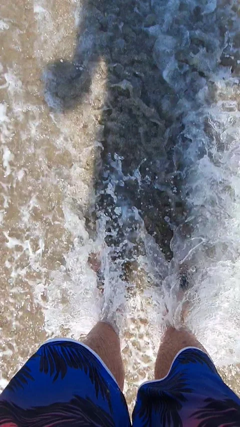 Standing on beach watching surfing Stock Footage 148128051