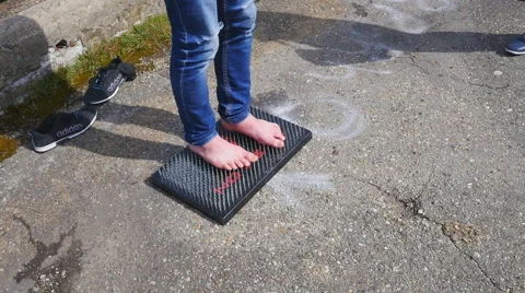 Standing on a bed of nails bare soles Stock Footage 68348811