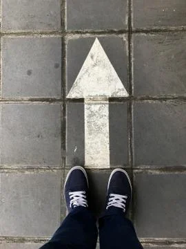 Standing behind the arrow that is mean "keep go ahead". Leadership, uniquenes Stock Photos