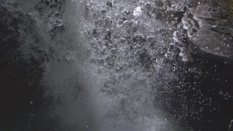 Standing behind a waterfall in slow motion, underneath a waterfall Stock Footage 231798426
