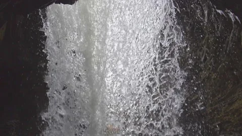 Standing behind a waterfall in slow motion, underneath a waterfall Stock Footage 231798497
