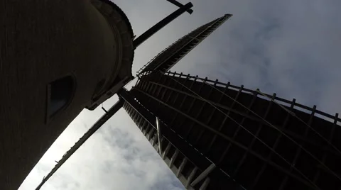 Standing beneath typical dutch windmill sails moving by wind at a steady  4k Stock Footage 61395997