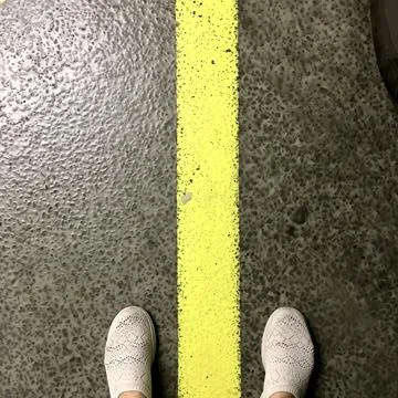 Standing between the line Stock Photos