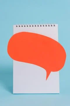 Standing blank spiral notepad speech bubble above lying cool pastel retro Stock Photos