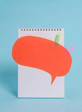 Standing blank spiral notepad speech bubble arrow banners above lying cool... Stock Photos