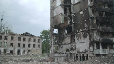 Standing burnt frames of abandoned buildings after the airstrikes Stock Footage 230691747