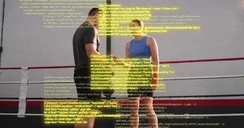 Standing couple in workout clothes facing each other in boxing ring with red Stock Photos