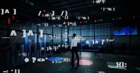 Standing data analyst analyzing in control room, with holographic charts and 스톡 사진