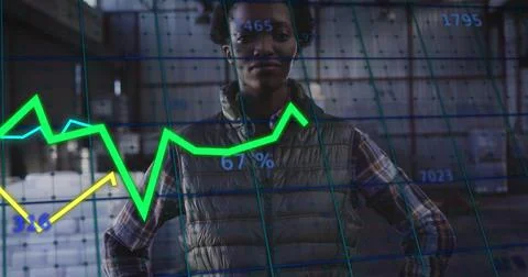 Standing data analyst wearing puffer vest scanning warehouse, overlaid with neon 写真素材