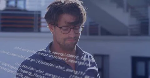 Standing developer analyzing floating code overlay on rooftop terrace, with Stock Photos