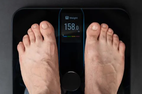 Standing on electronic weight Stock Photos