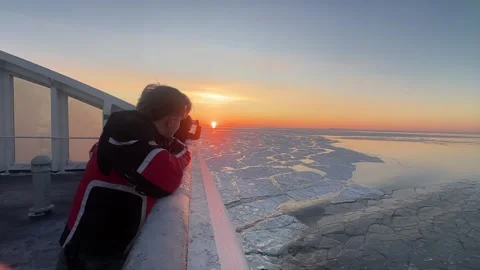 Standing on Ferry Deck Watching Sunset in Winter on the Baltic Sea 4K video 動画素材 331091974