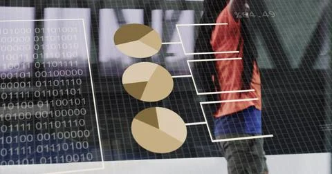 Standing host wearing red jacket at stage, digital screen, pie charts, binary Foto stock