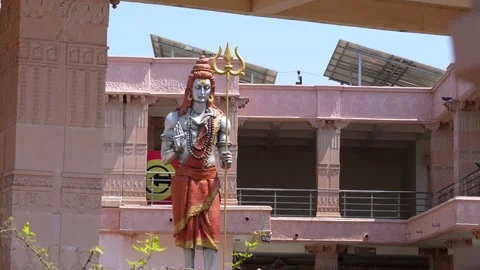 Standing Lord Shiva Statue in Temple Courtyard with Architecture Background.. Stock Footage 336884201