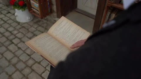 A standing man is reading a book Stock Footage 253786363