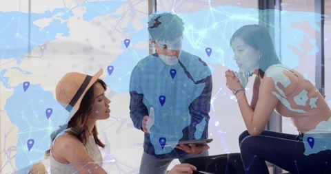 Standing man tapping tablet and causing blue map overlay with pins, team Stock Footage 322704621