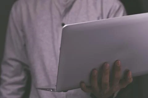 A standing man using a laptop computer Stock Photos
