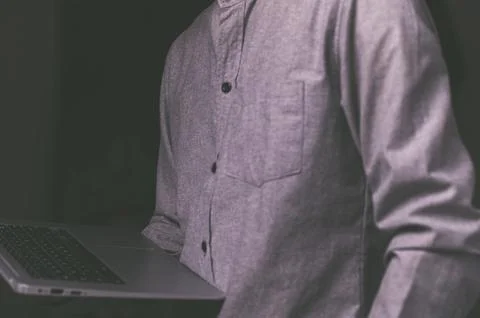 A standing man using a laptop computer Stock Photos