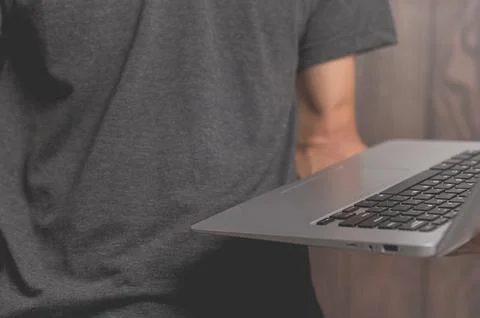 A standing man using a laptop computer Stock Photos