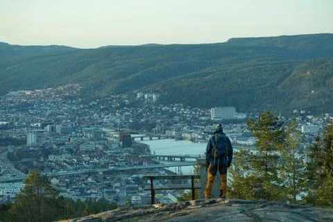 Standing on a mountain and looking at the city down. Stock Photos