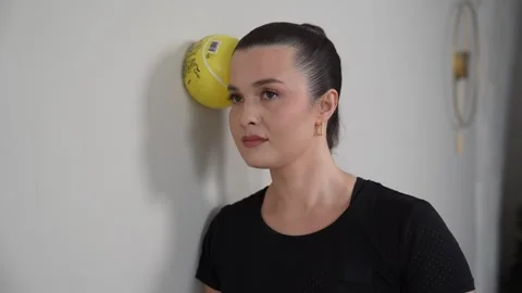 Standing Neck Isometrics Cervical Rotation At Wall with Ball Stock Footage 314189673