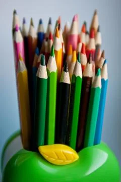 Standing out from the crowd concept with colored pencils. Stock Photos