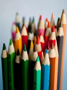 Standing out from the crowd concept with colored pencils. Stock Photos