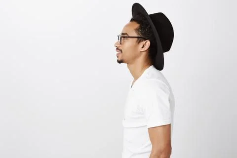 Standing in queue to grab coffee. Studio shot of stylish urban dark-skinned Stock Photos