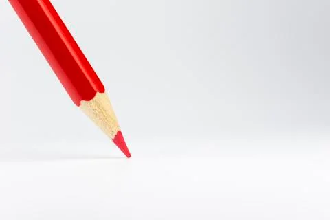 Standing red colored pencil on a white background. Stock Photos