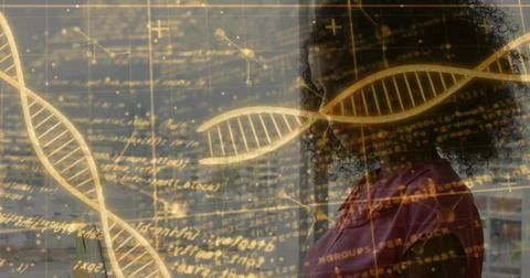 Standing researcher examining code and network diagrams in lab, with golden DNA Stock Photos