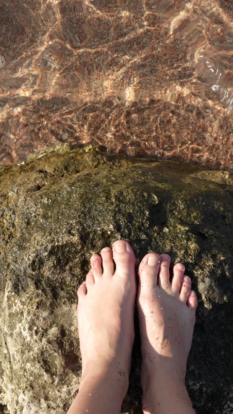 Standing on a rock in crystal-clear water of Lake Issyk-Kul Stock Footage 342024975