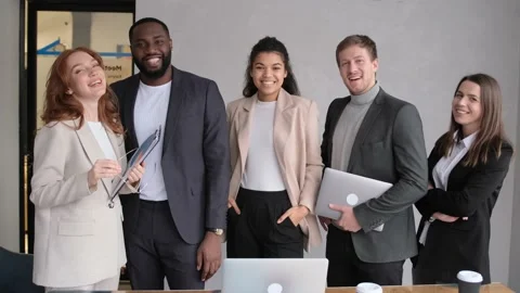 Standing in row smiling diverse team posing differently looking at camera. Happy Stock Footage 167335336