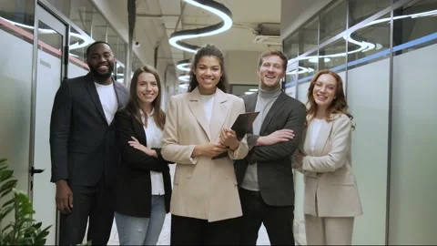 Standing in row smiling diverse team employees in the office looking at camera Vídeo Stock 169657675