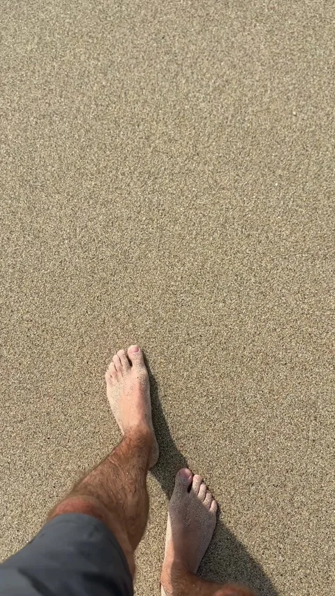 Standing on a sandy beach in bare feet and waiting for the waves Stock Footage 322073208