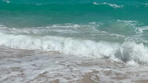 Standing on the sandy beach, Close-up - waves hitting the beach Stock Footage 321406889