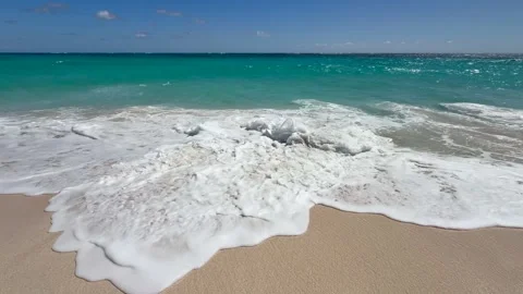 Standing on the sandy beach, waves hitting the beach and surrounding Stock Footage 321405760