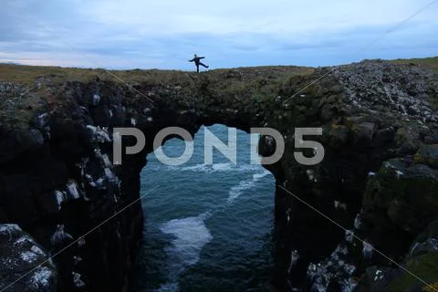Standing on a Sea Arch.jpg Stock Photos