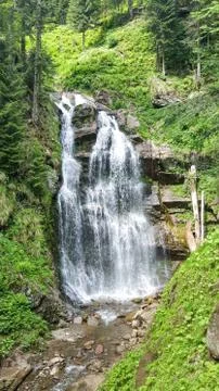 Standing side by side at the waterfall on the way to the top of the waterfall Stock Photos