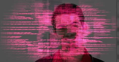 Standing software developer facing viewer in gray room with pink code overlaying Stock Photos