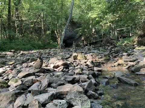 Standing stone at the base of a rock bridge Stock Photos