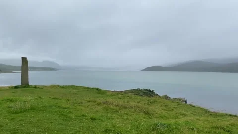 Standing stone with Celtic symbol by River Dionard in Kyle of Durness Stock Footage 241477868